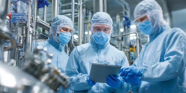 Engineers collaborating in a GMP-compliant life sciences facility to validate and ensure reliable, compliant process systems